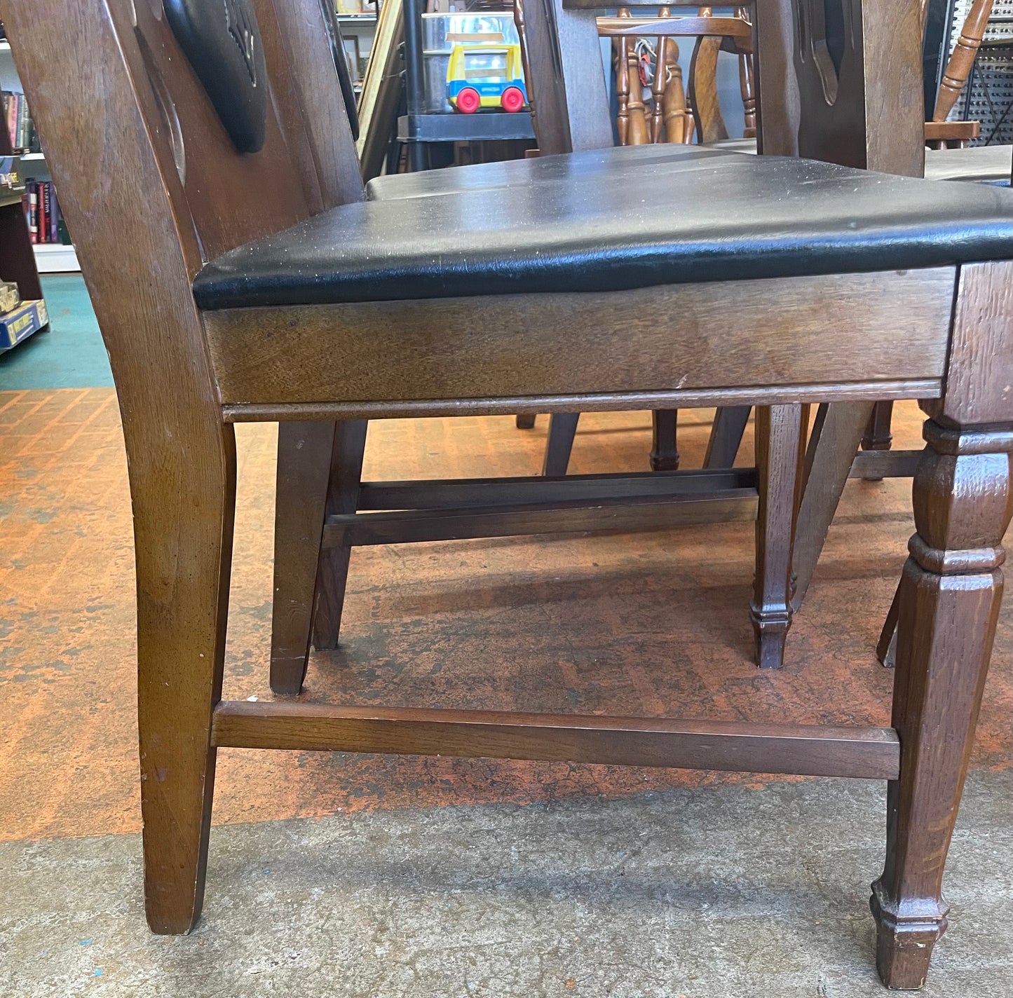 Oval Dining Table With 1960s Spanish Revival Solid Pecan Wood and Black Vinyl Dining Chairs - Set of 5