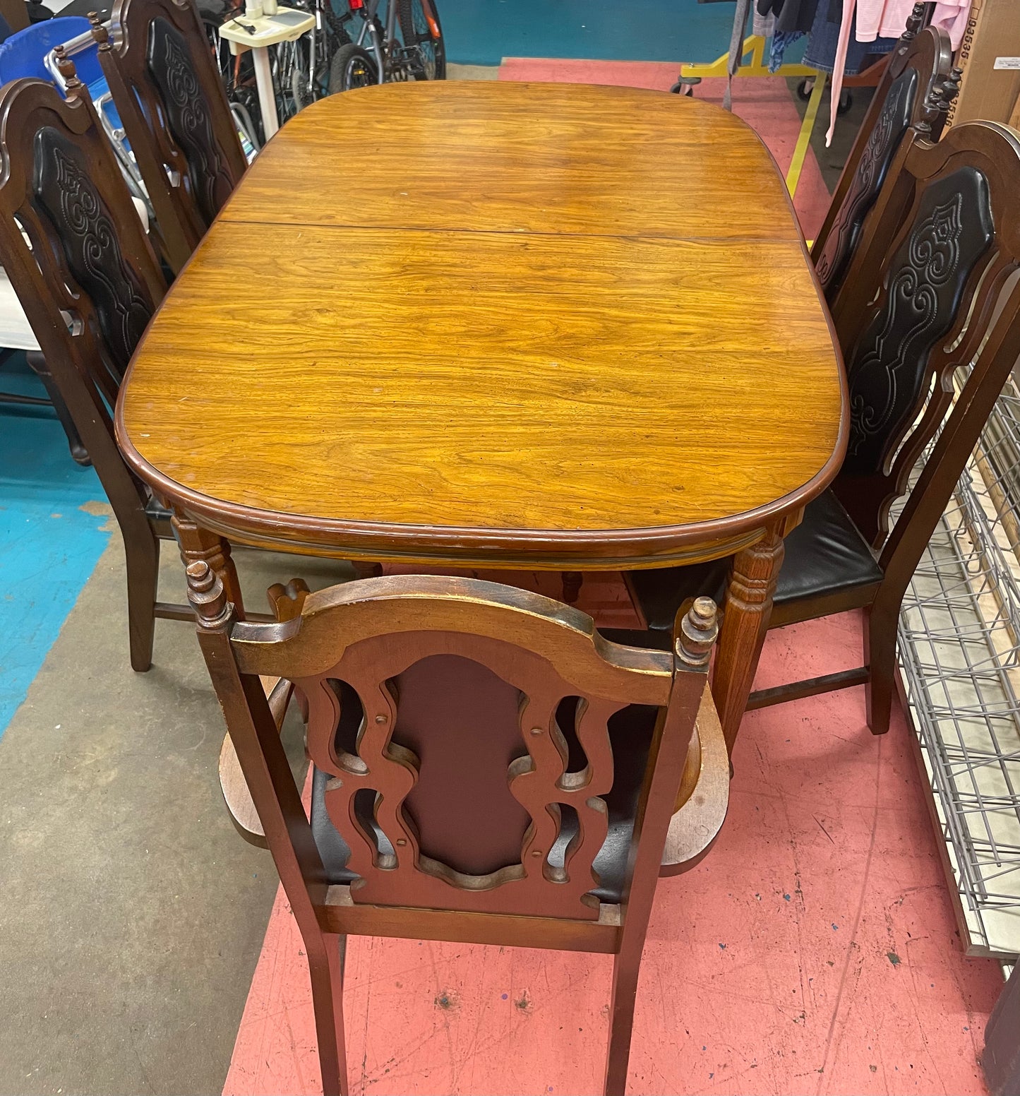 Oval Dining Table With 1960s Spanish Revival Solid Pecan Wood and Black Vinyl Dining Chairs - Set of 5